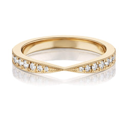 A gold band ring with a pinched design featuring diamonds along the top edge, shown against a white background.