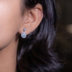  white gold diamond earring with multiple smaller diamonds set around it.